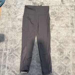 Gray athletic leggings with pockets and small zipper pocket